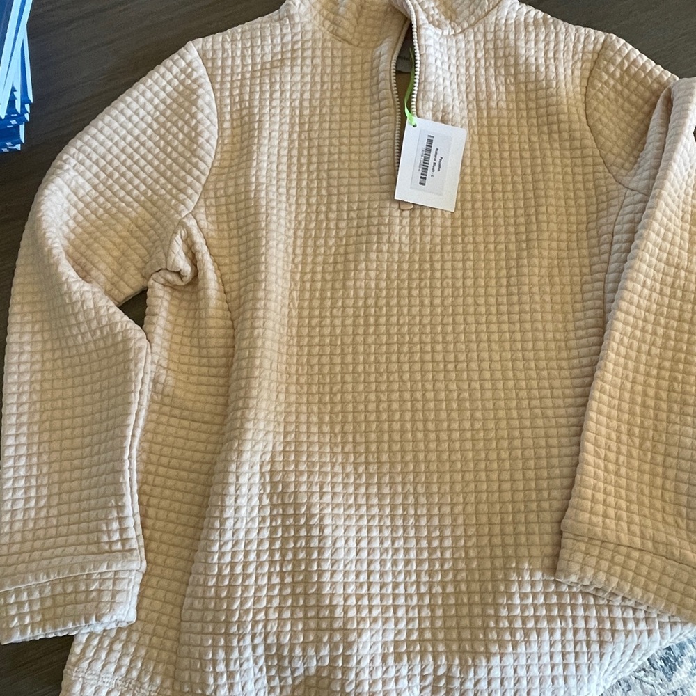 Beautiful, stylish new Pocomo pullover in Natural Blush. Color is a rich cream.